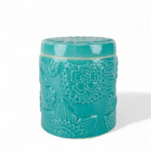 handcrafted ceramic jar with embossed floral design in a glossy turquoise glaze