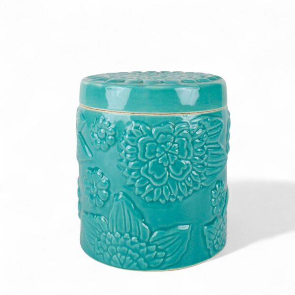 handcrafted ceramic jar with embossed floral design in a glossy turquoise glaze