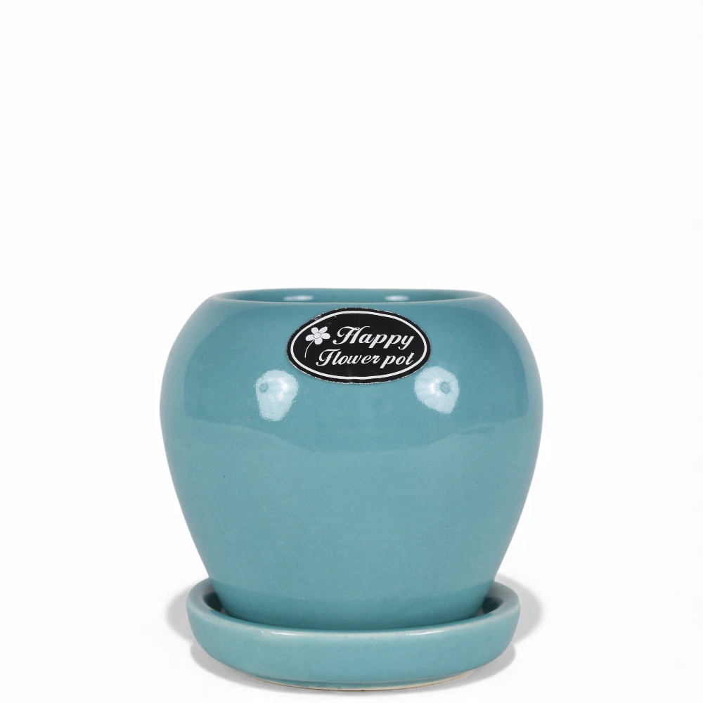 Bring a refreshing touch of color to your home with our Aqua Blue Glossy Round Ceramic Planter with Tray. This handcrafted planter features a soft rounded design with a high-gloss aqua glaze that instantly brightens up any space. The matching ceramic tray ensures proper drainage while keeping surfaces neat and clean. Perfect for succulents, small plants, or herbs, this versatile planter adds charm to desks, windowsills, and tabletops. Durable, stylish, and full of personality — a perfect piece to elevate your indoor greenery with a touch of handcrafted elegance.