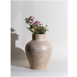 The Sandstone Glow Handcrafted Ceramic Vase embodies quiet elegance through its smooth contours and earthy, sun-kissed finish. Crafted from premium ceramic, this vase features a balanced silhouette and subtle surface variations that reflect the beauty of handmade artistry. Its warm neutral palette pairs effortlessly with floral arrangements or minimalist styling, making it suitable for coffee tables, shelves, bedside consoles, and hospitality décor. The gentle sheen enhances its refined look while preserving an organic, natural character. Sandstone Glow Handcrafted Ceramic Vase