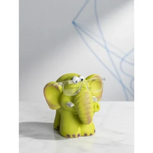 The Smarty Elephant Glasses Holder is a fun and functional tabletop accessory that blends charm with practicality. Designed in a bright lime-green finish with soft pastel detailing on the ears and feet, this adorable elephant features a sturdy trunk and face structure that securely holds eyeglasses when not in use. Its expressive eyes and cute sculpted details give it a lively personality, making it perfect for desks, bedside tables, study corners, kids’ rooms, and office décor. Beyond being a simple glasses stand, it doubles as a decorative showpiece that instantly adds character to any space. Smarty Elephant Glasses Holder