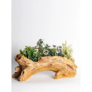The Rustic Driftwood Log Planter is designed to replicate the raw beauty of natural wood. With detailed bark textures, carved knots, and flowing grain patterns, this planter captures the authentic look of a weathered driftwood log. Its elongated horizontal design makes it ideal for multi-plant arrangements, allowing you to create a mini garden display in one single piece. The natural wood-tone finish enhances its organic appeal, making it perfect for farmhouse décor, balcony styling, café interiors, and garden-themed displays. The arch-style structure adds visual depth and makes it stand out as a decorative statement piece rather than just a planter